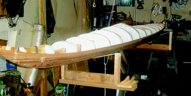 The stripping of the Guillemot kayak's hull with Western red cedar is completed.