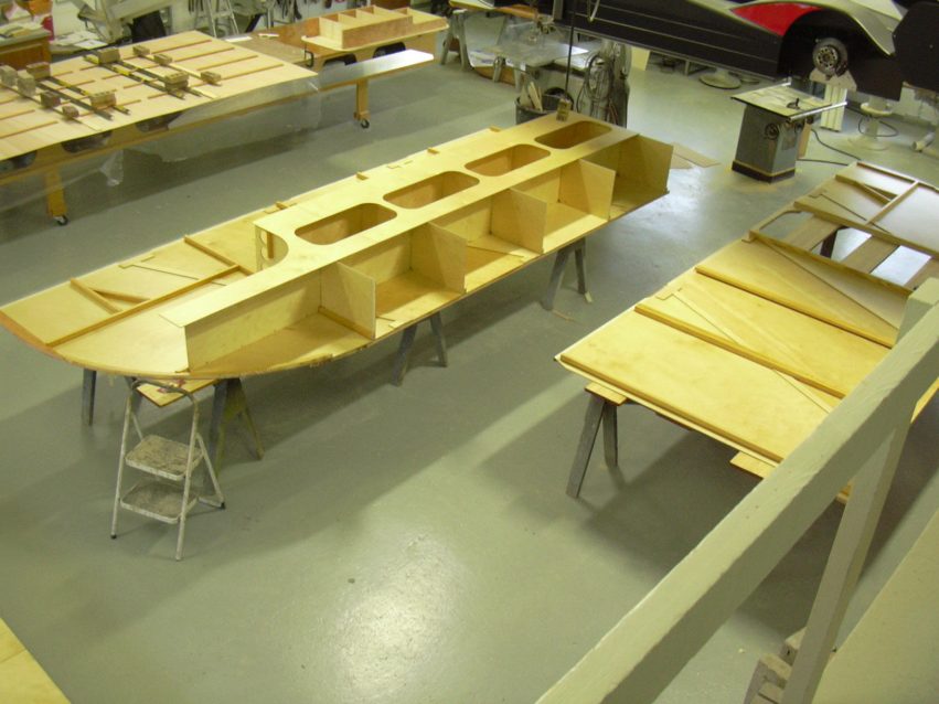 Top and bottom enclosed racecar trailer assembly in progress.