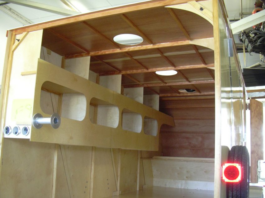 Three 12” diameter holes were cut into the top of the racecar trailer as skylights sealed with of polycarbonate.