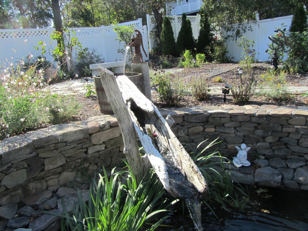Garden Fountain made from a hollow piece of driftwood coated with WEST SYSTEM Epoxy.