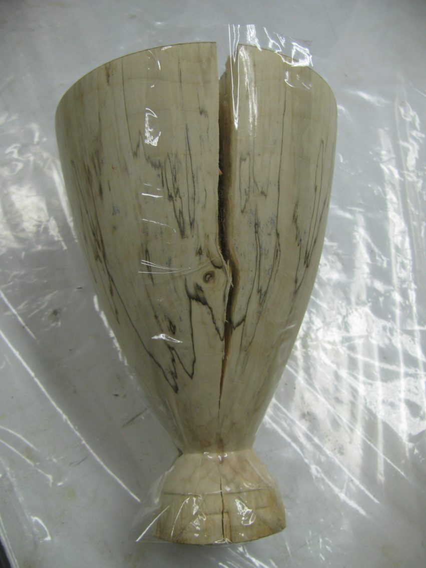Clear cellophane tape applied over the crack in the wooden goblet to contain the epoxy.