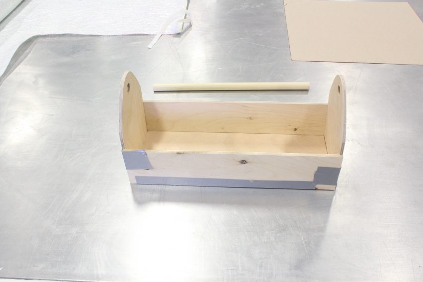 The toolbox takes shape as its sides folded up and taped,