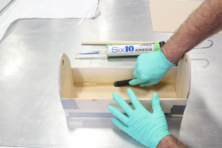 Applying fillets to the joints in the composites merit badge toolbox with Six10 Thickened Epoxy Adhesive.