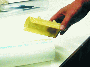 Create a positioning fixture by laminating several layers of fabric over the part to be machined. Use mold release, tape or plastic wrap to protect the part. Glue the drill bushing in position with G/5 Five-Minute Adhesive.