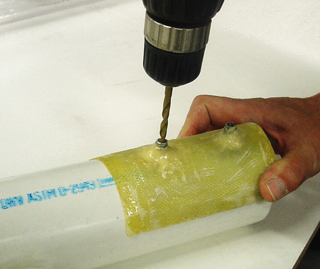 Create a positioning fixture by laminating several layers of fabric over the part to be machined. This is how you make shop tools quickly.Use mold release, tape or plastic wrap to protect the part. Glue drill brushing in position with G/5. When placed on the part (top), the fixture guarantees accurate positioning of the drill on every part (above)