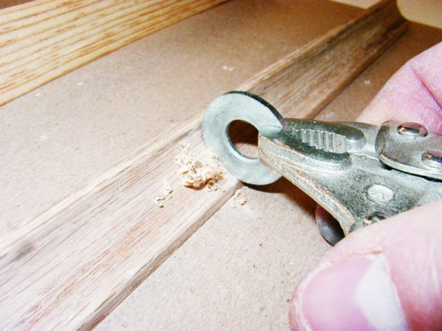 Flat steel washers shaped and sharpened on a bench grinder are useful for scraping small concave surfaces like wood moldings and epoxy fillets.