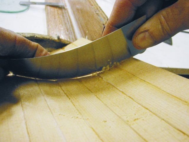 Thin scrapers can be bent to remove material inside shallower concave surfaces.