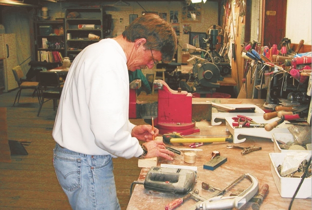 Bill Coberly of the Monday night boatbuilding class lays out a tiller handle.
