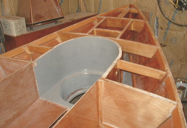 The rudder case at the back of the plywood sharpie cockpit.