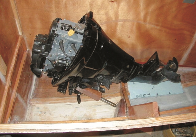 The motor well showing the motor in the raised position. The motor is mounted to the pivoting yoke, left.