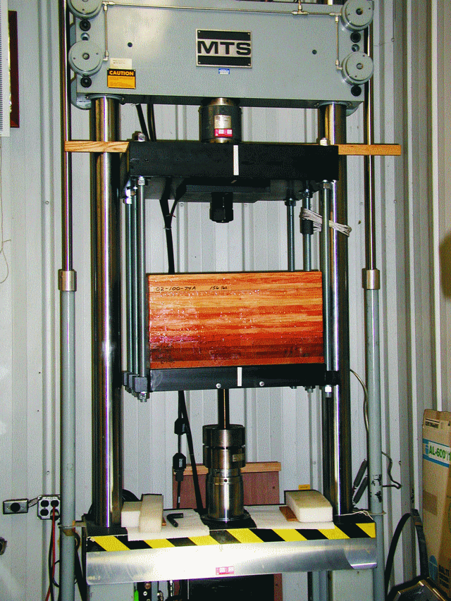 The MTS test machine with the test apparatus and 1 1/2" silicon bronze bolt test sample before the test of large bonded-in fasteners.
