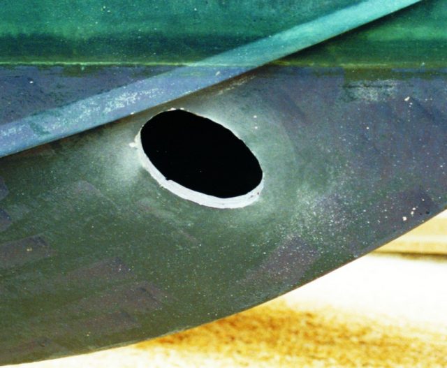 The holes for the bow thruster tube were cut through each side of the hull, after determining the thruster's location.