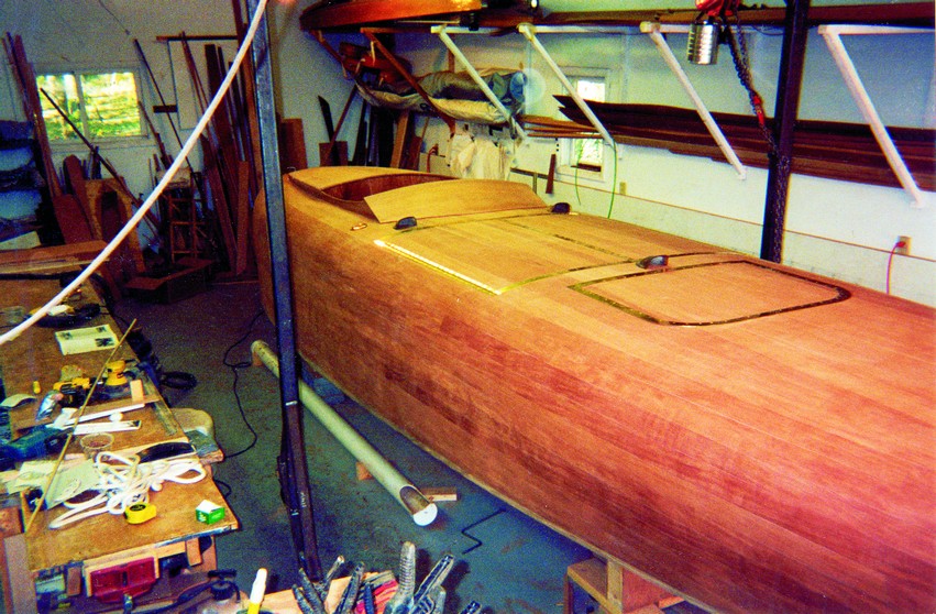 Final fairing and finishing was a lot of work. After many hours of longboarding and block sanding, four coats of tung oil, ten coats of Epiphanes no-sand, and three coats of Z-spar Flagship, it was pretty much done.