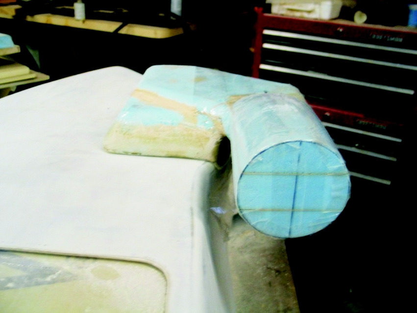 The air scoop mold viewed from the front. The mold is in the process of being covered with clear packaging tape to preven epoxy from bind and to provide a smooth interior surface in the finished part.