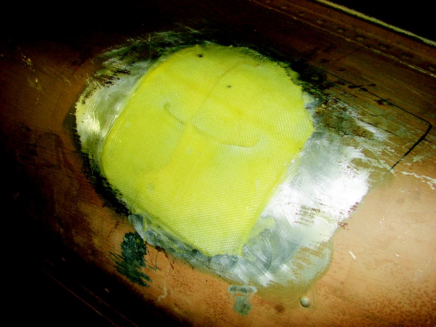A single layer of glass was applied to the outside of the hull and smoothed into the thickened epoxy.