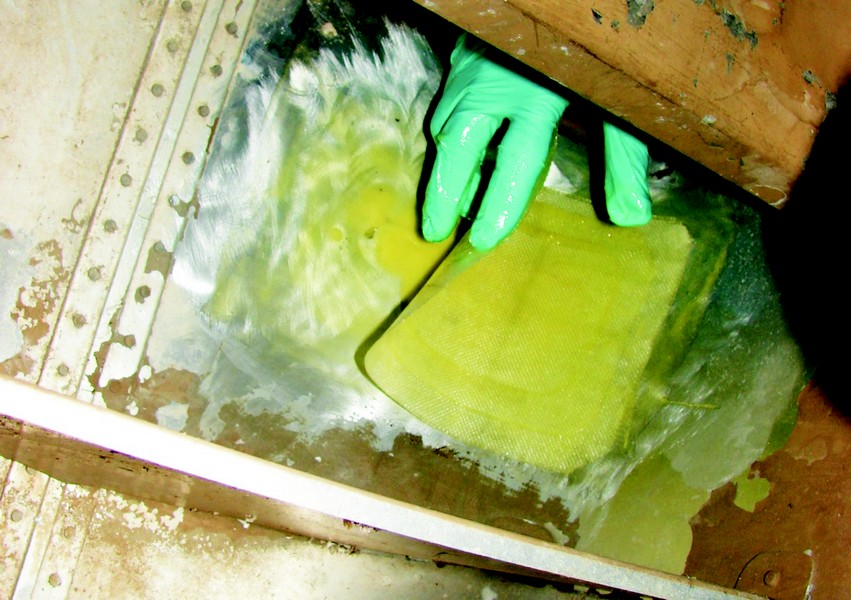 Three layers of glass were laid in position on the inside of the hull and lightly squeegeed to remove trapped air.