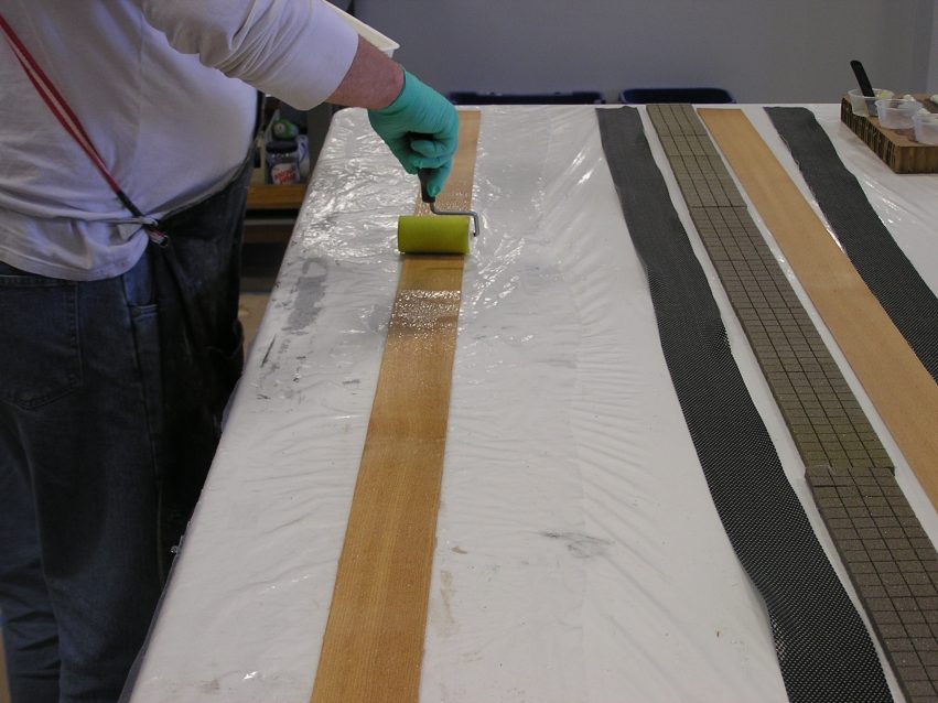 Wetting out the wood veneer with WEST SYSTEM Epoxy.