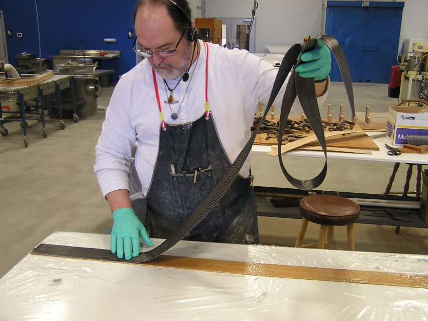 Layering the carbon fiber on the wood veneer.