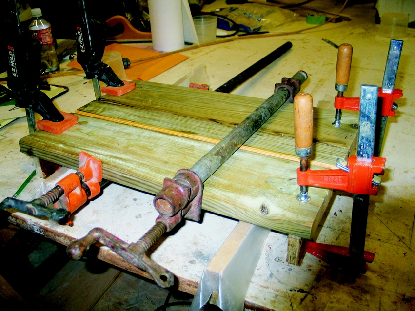 Figure 1: Alternating bar clamps and clamps at the end of the panel to keep it flat while the epoxy cures.