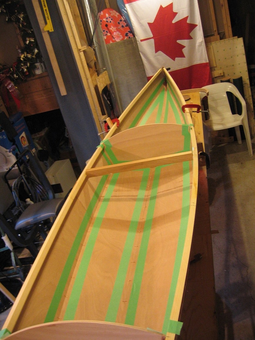 Chris applied masking take to keep the epoxy neat at the seams of this stitch and glue Chesapeake 16 kayak.