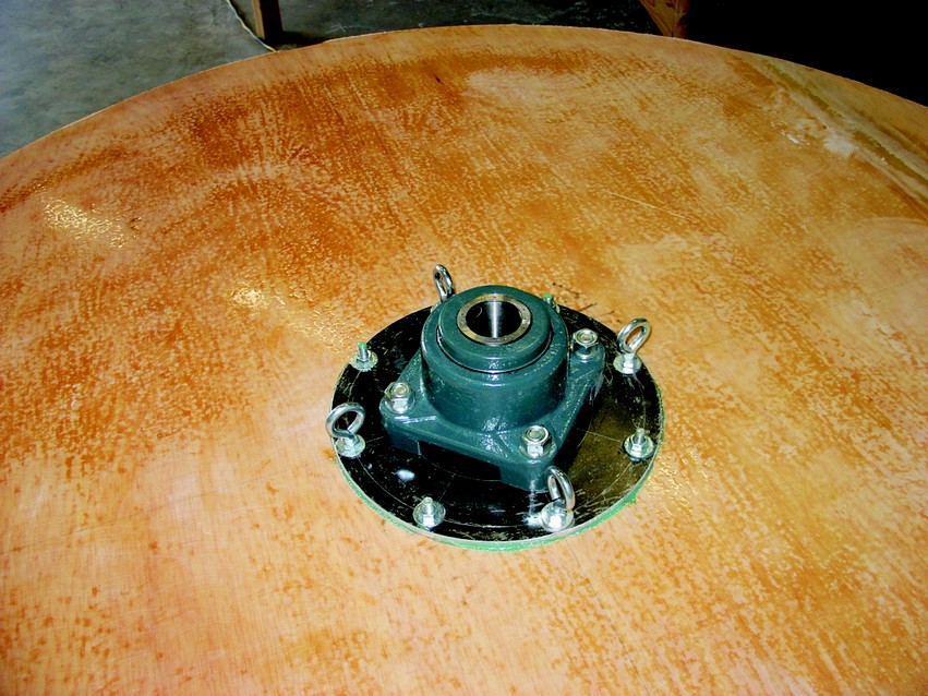 The middle bulkhead with main bearings attached. The eyebolts had cables connected to the lower bulkhead rim to carry the cylinder weight.