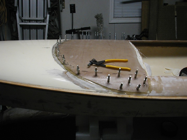 A molded fiberglass deck extension is clamped in place using Cleco clamps.