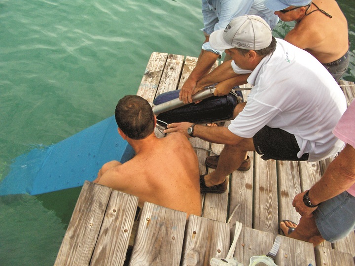 Pulling the 160 lb, 9'-long rudder onto the dock after it was removed from the boat while it was still in the water.