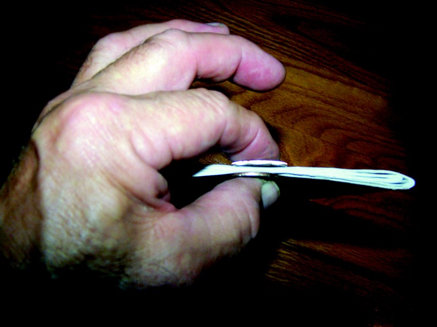 Coin and needle method of determining laminate thickness when using reinforcing fiber tape.