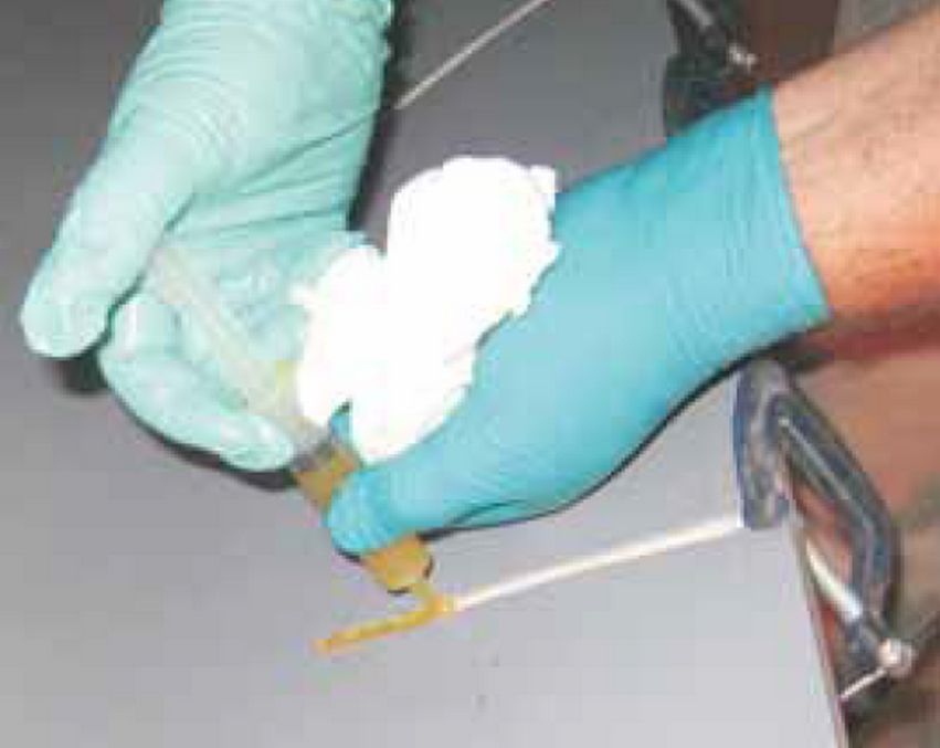 Injecting G/flex into a widened crack. Note: Paper towel in hand to clean up after rampant sloppiness.