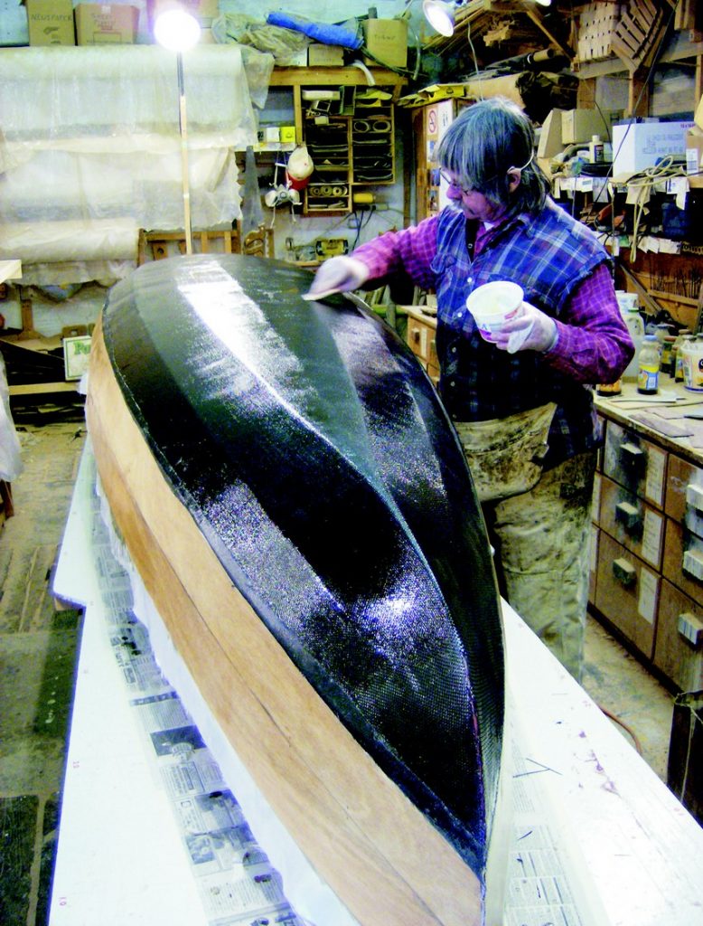 Boat builder Skip Izon of Grand Bend, Ontario, takes a Bufflehead hull from the cutout strakes and the mold.