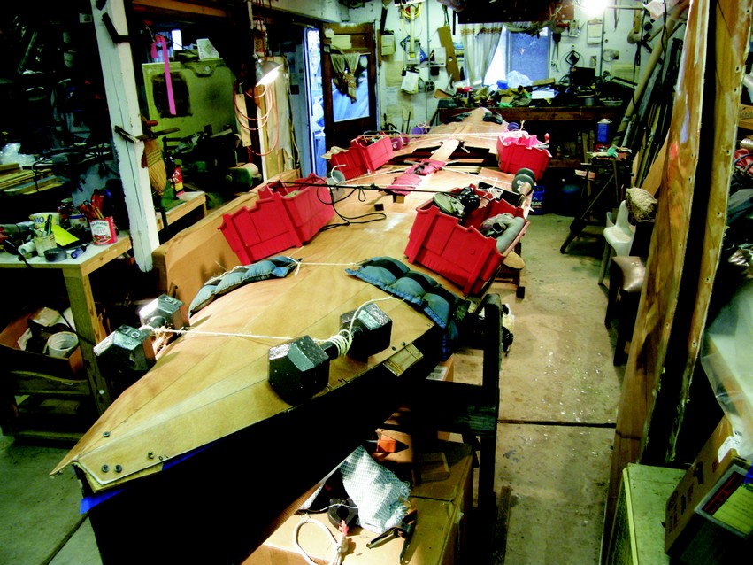 A deck being glued to a hull in Hugh Horton's shop.