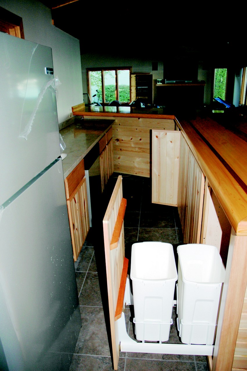 The behind-the-bar trash drawer/cabinet door.