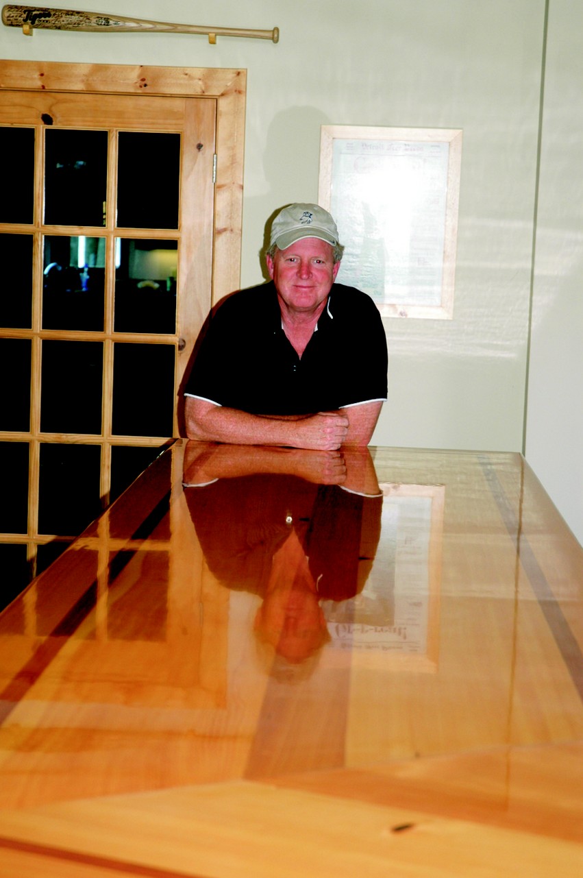 The happy owner, Tim, bellying up to his new custom bar top, reflected in four coats of High-Gloss Spar Varnish.
