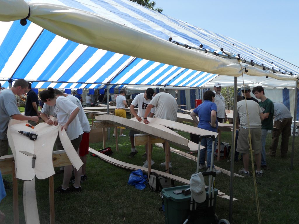 Nine families begin the building process by stitching the first strakes together with copper wire.