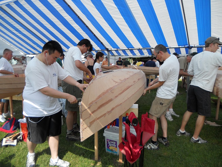 On day two of the Family Build Weekend, the bottoms of the interiors were fiberglassed. The now rigid hulls were rolled over and the copper stitching was removed.