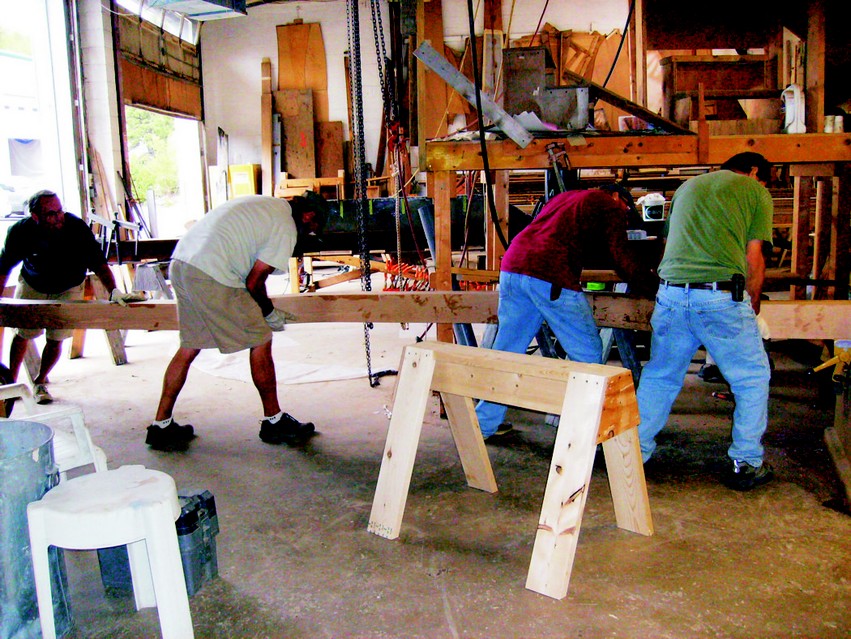 One of the voyaging canoe's laminated iakos is being planed to final thickness.