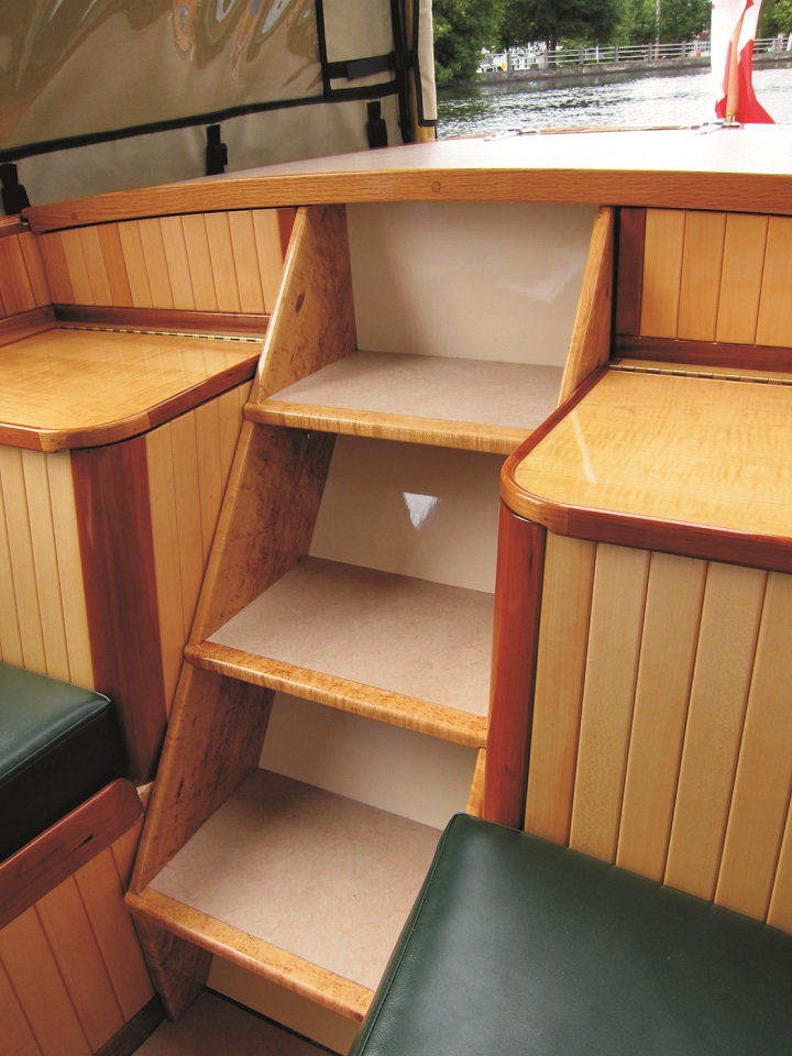 The white cedar paneling on either side of the aft stairs is trimmed with cherry.