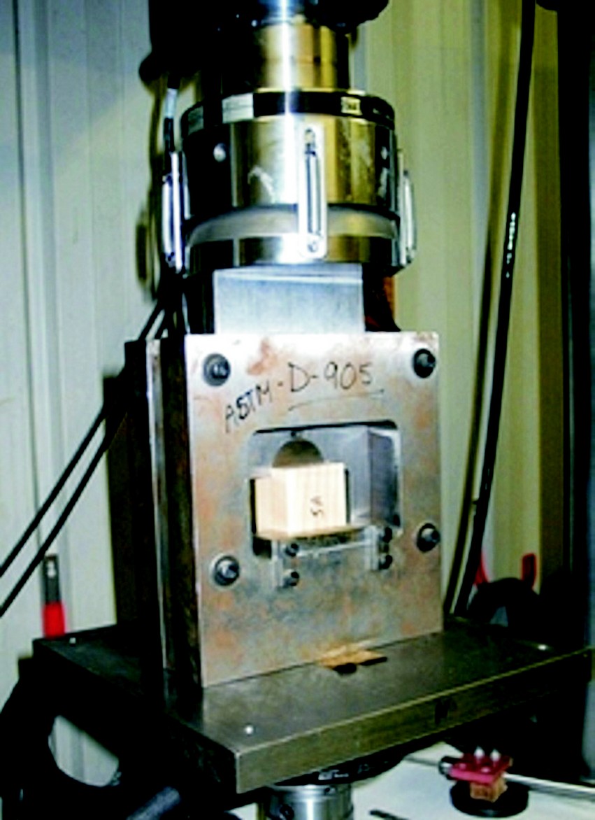 The ASTM D905 test in progress. the test fixture is designed to minimize peel by presenting the sheer force on the specimen parallel to the glue joint.