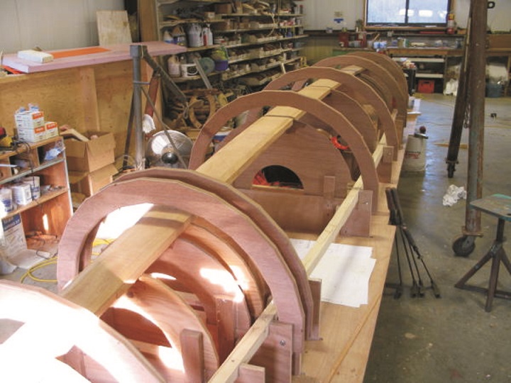 The building frame of the architectural column, with the permanent Meranti plywood half-bulkheads and vertical reveals for a column half glued in place.
