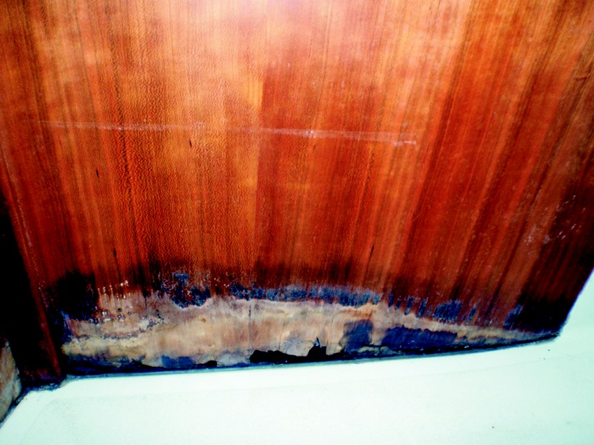 4. All the wood below the dotted line was removed. The cut was made with a saber saw set to create a shallow scarf angle. The actual cut was a straight line so the replacement piece could be easily cut to match. Sections of water-damaged bulkheads were removed and new bulkhead material, supplied by C&C, was scarfed in.
