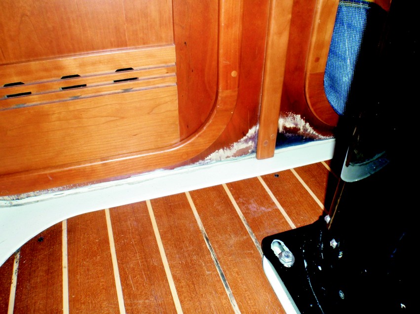 2. This water damage is just forward of the mast. One doorway is to the head—the other is to the V-berth. Water which likely came from the anchor locker had wicked up through the sole to the bulkhead/cabin sole gap.