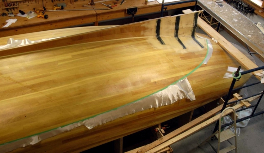 The keel and skeg were glued over 3 continuous layers of fiberglass over the strip planking.