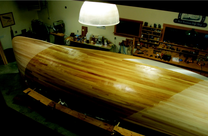 Midway through Fiberglassing a strip-planked canoe: The cloth wrapped easily around the stem and followed the complex shape of the fantail.