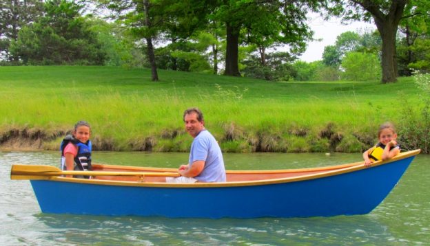 Jon and his daughters aboard his homebuilt skiff, MISS HAN-LEY.
