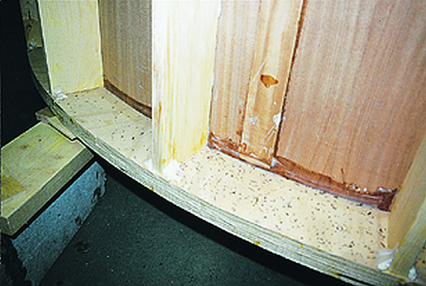 Detail of the back of the curved wall showing 1"x4" studs, 2" plywood plates, and a plywood butt block. Keep the butt block 1/5" shorter than the plywood panel on each end so it will clear the top and bottom plate.