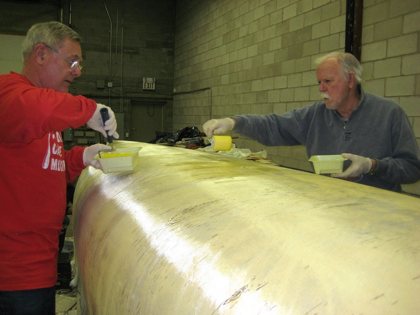 Painted with a birch bark pattern, the North canoe receives another coat of epoxy.