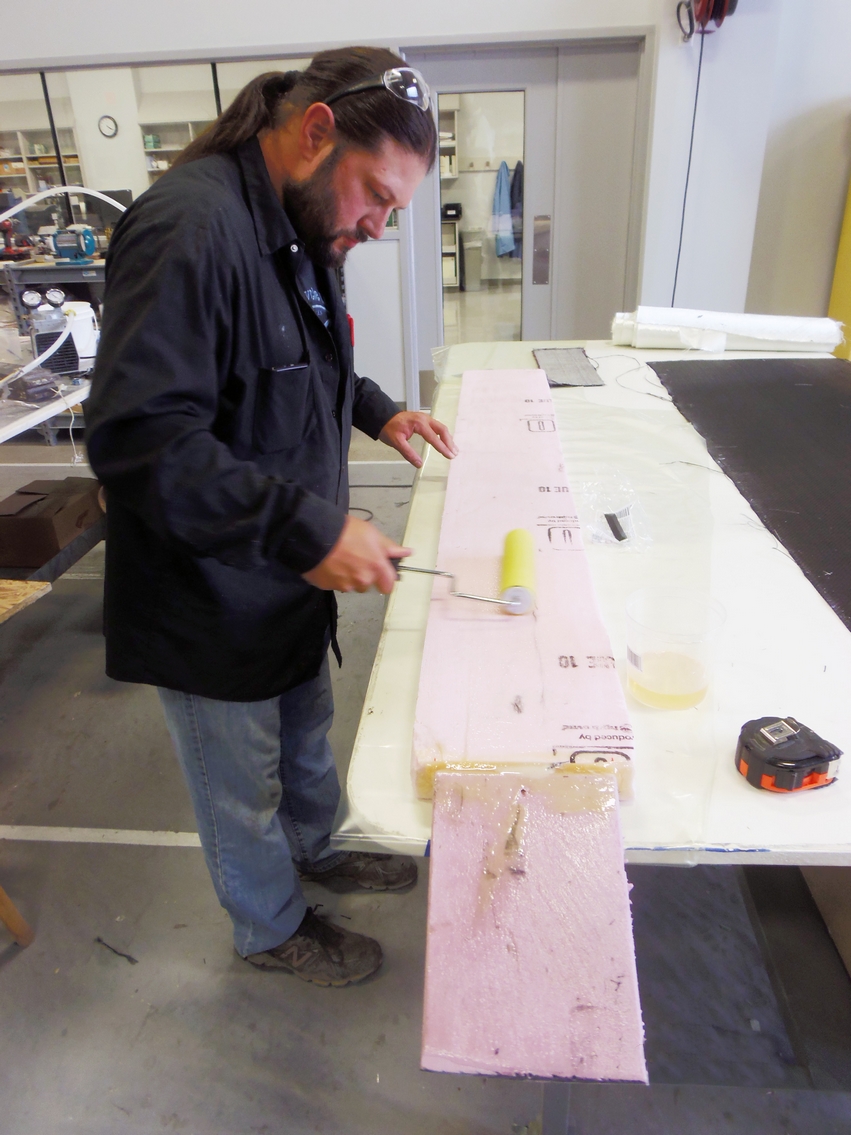 Daryl applies epoxy to the foam insulation just before wrapping it in fiberglass to create his new dirt bike loading ramp.