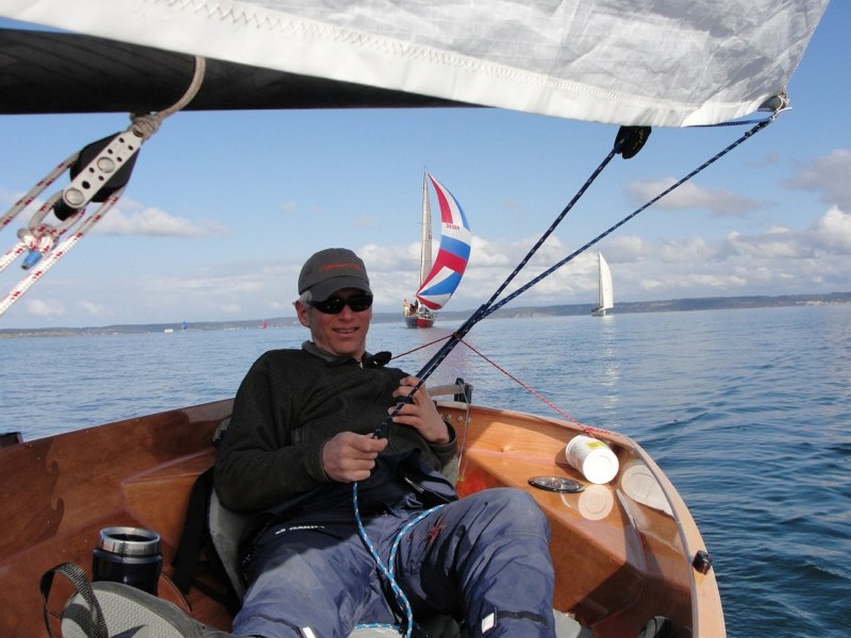 Russell Brown sailing a PT11 in a regatta. Known for his meticulous craftsmanship, he wrote Epoxy Basics as a guide for other boat builders.