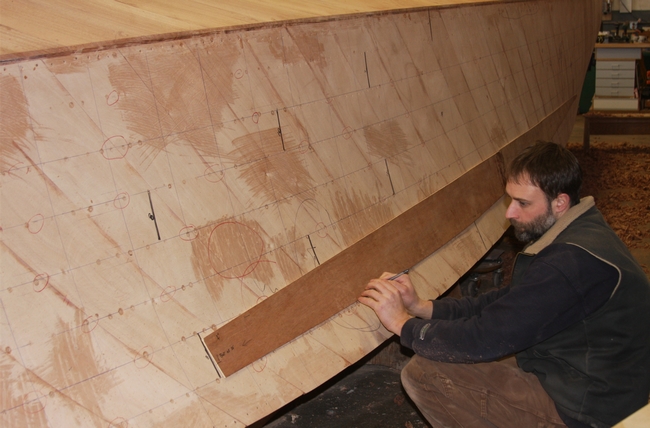 Before the final "show planks" are bonded to the Limousine's hull with epoxy, templates are made and placed on the hull to make sure the characteristics of the wood are uniform and parallel to the lines of the boat. Each of the templates are numbered to make sure that the planks, when cut using the templates, are placed in the exact position.