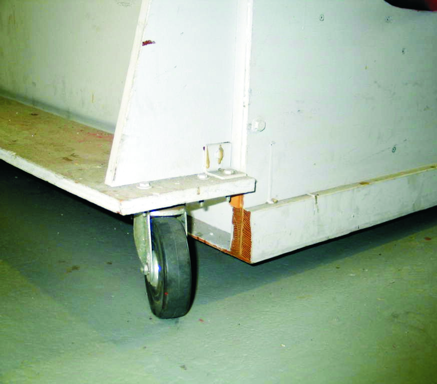 2— Four rubber casters, one at each corner, are mounted to brackets at the ends of the table to give it portability.
